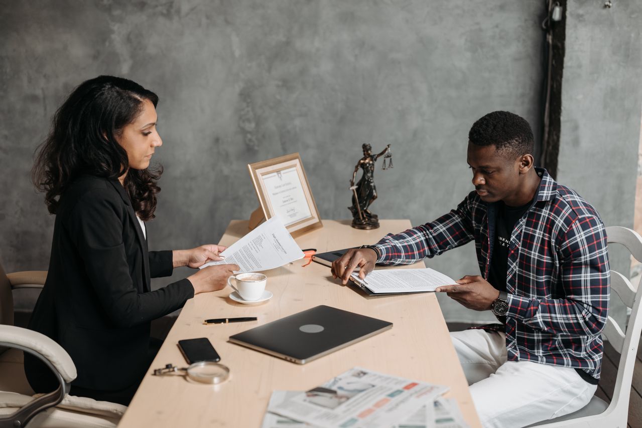 Financial advisor helping a client understand debt repayment options and legal debt counselling